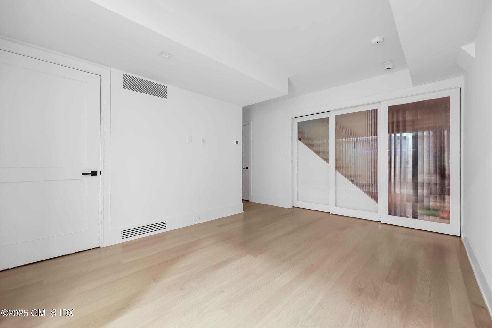 187 Field Point Road, Unit B Greenwich, CT 06830 - Photo 24 of 32 a view of an empty room with wooden floor