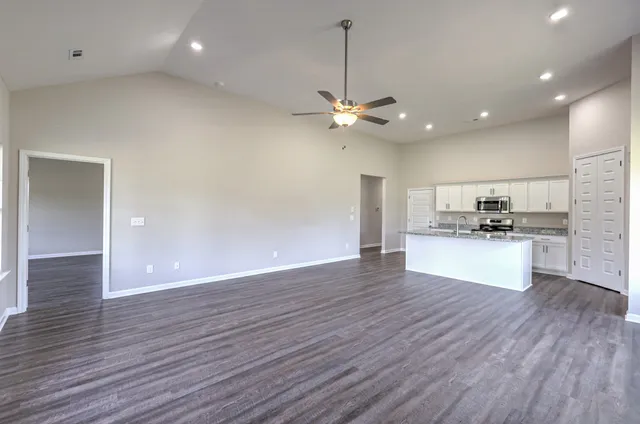a kitchen with stainless steel appliances granite countertop a sink and a refrigerator