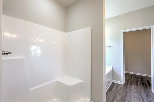 a spacious bathroom with a double vanity sink and a mirror