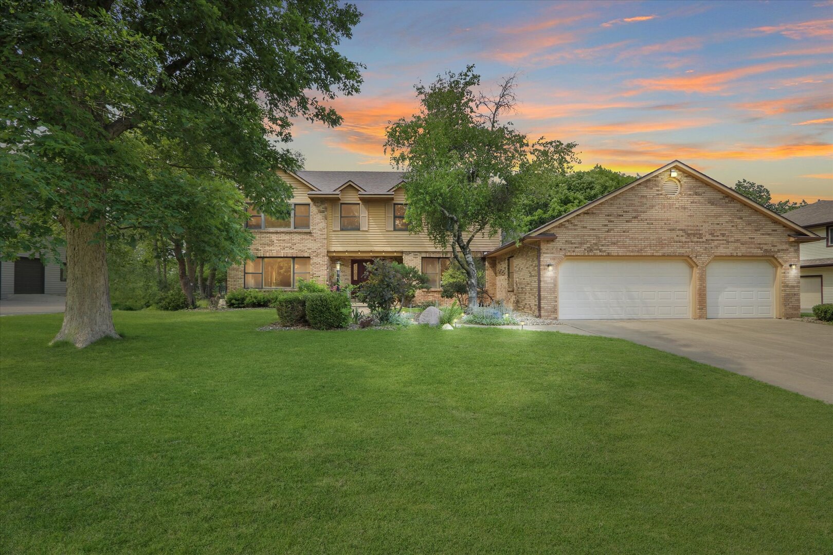 a front view of a house with a garden
