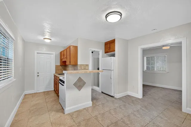 a view of kitchen with sink and refrigerator