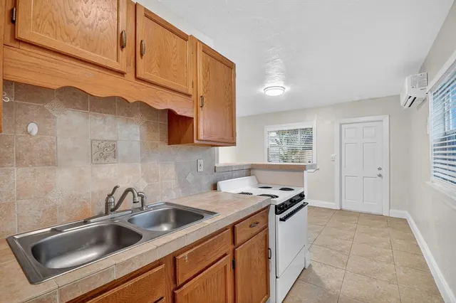 a kitchen that has a sink and a stove