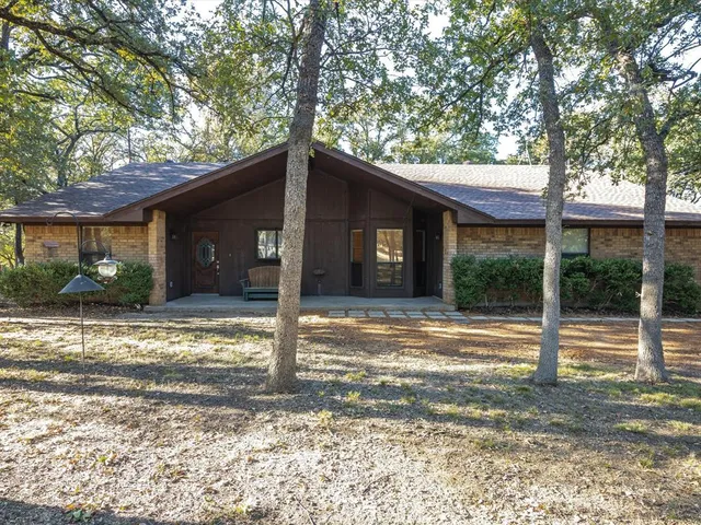 a view of a house with a tree in front of a house
