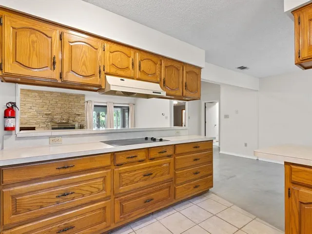 a kitchen with stainless steel appliances granite countertop a sink and cabinets