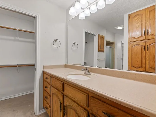 a bathroom with a sink a vanity and a mirror