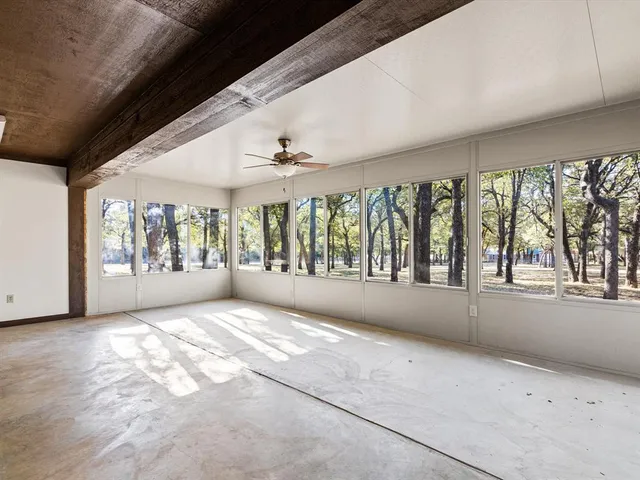 a big room with wooden floor and windows