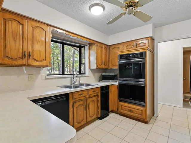 a kitchen with a sink appliances and cabinets