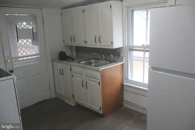 a kitchen with cabinets appliances and a window