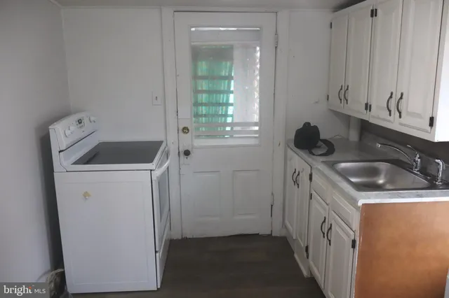 a utility room with a sink washer and dryer