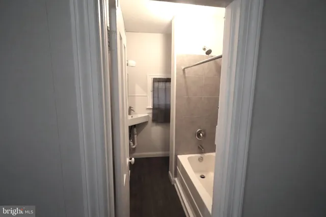 a bathroom with a tub and a sink