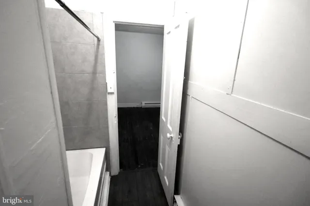 a bathroom with a shower and a mirror