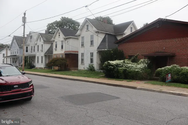 a view of a city street with a house