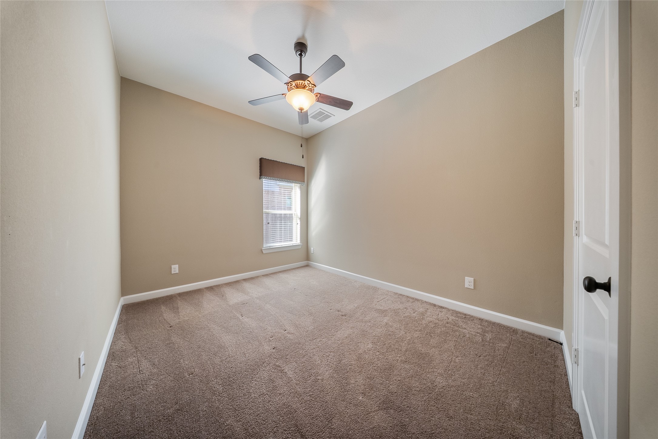176 Castlegate Lane Houston, TX 77065 - Photo 14 of 33 an empty room with windows and chandelier fan