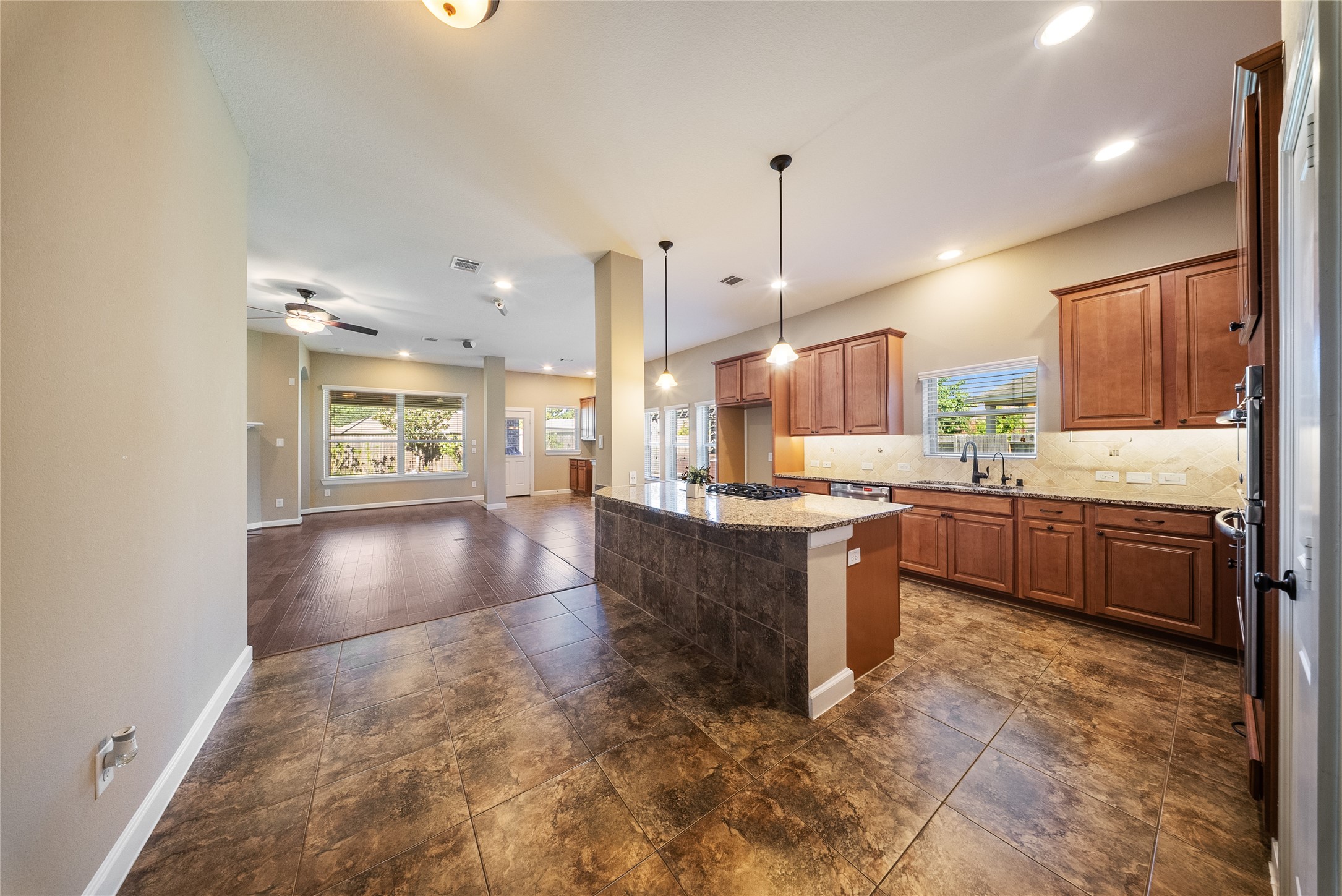 176 Castlegate Lane Houston, TX 77065 - Photo 15 of 33 a large kitchen with a large counter top a sink stainless steel appliances and cabinets