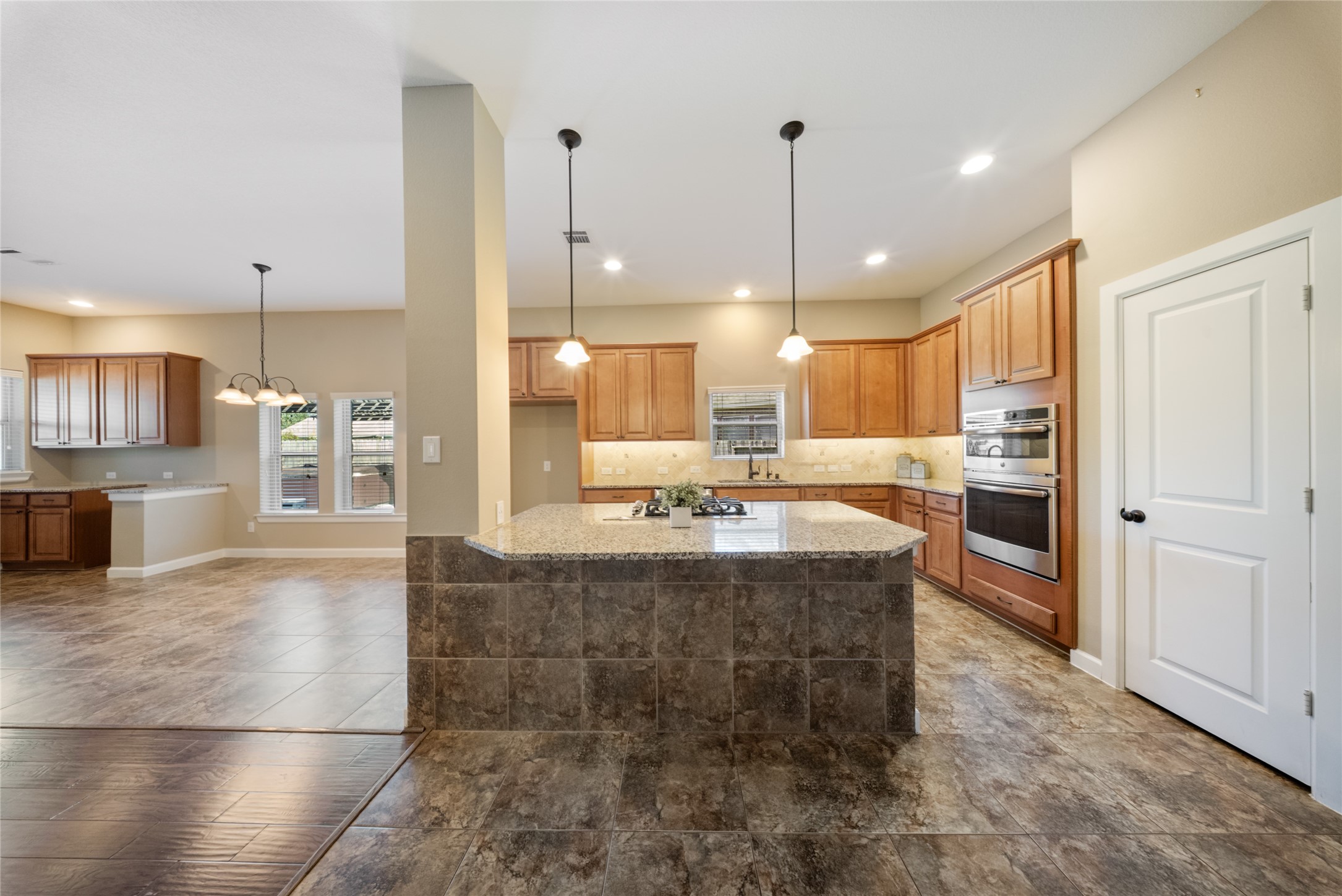 176 Castlegate Lane Houston, TX 77065 - Photo 16 of 33 a large kitchen with kitchen island a large counter top stainless steel appliances and cabinets