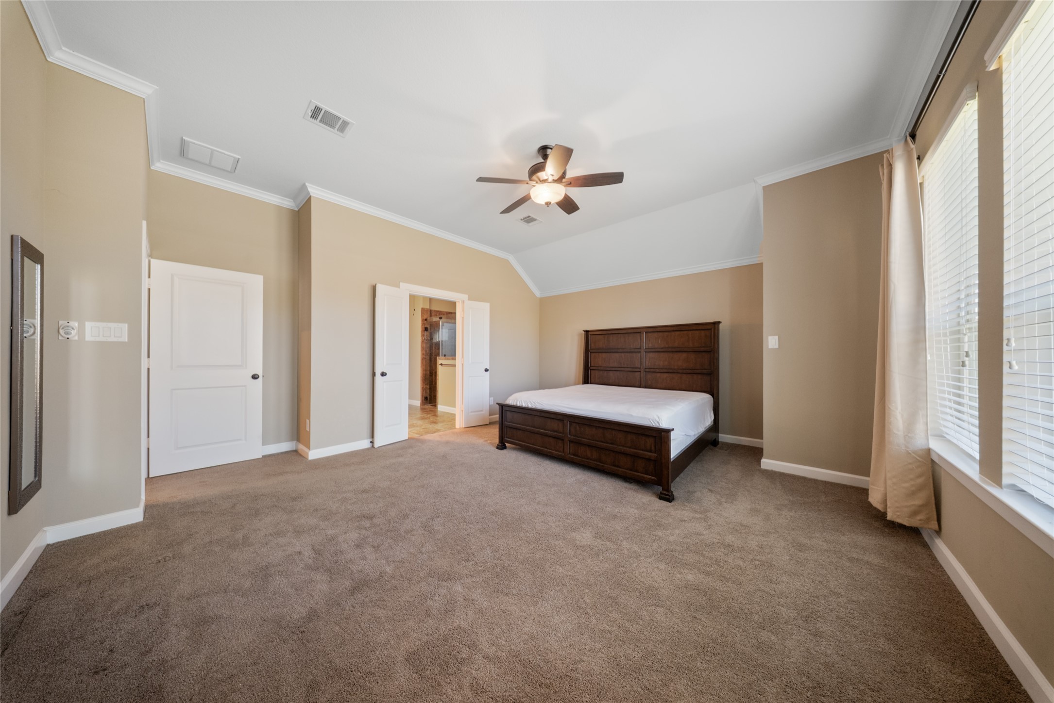 176 Castlegate Lane Houston, TX 77065 - Photo 19 of 33 a bedroom with a bed and a ceiling fan