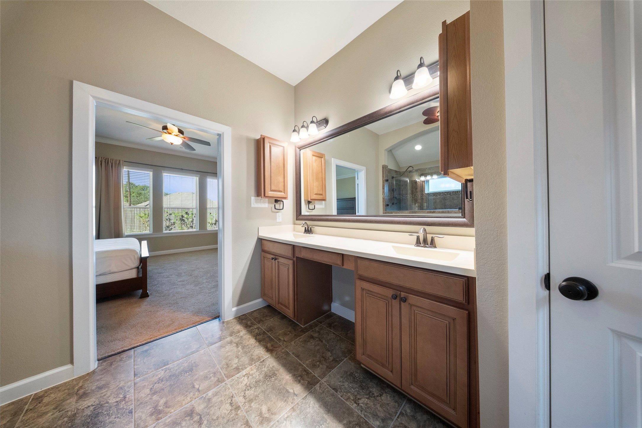 176 Castlegate Lane Houston, TX 77065 - Photo 22 of 33 a spacious bathroom with a granite countertop sink mirror and a bathtub