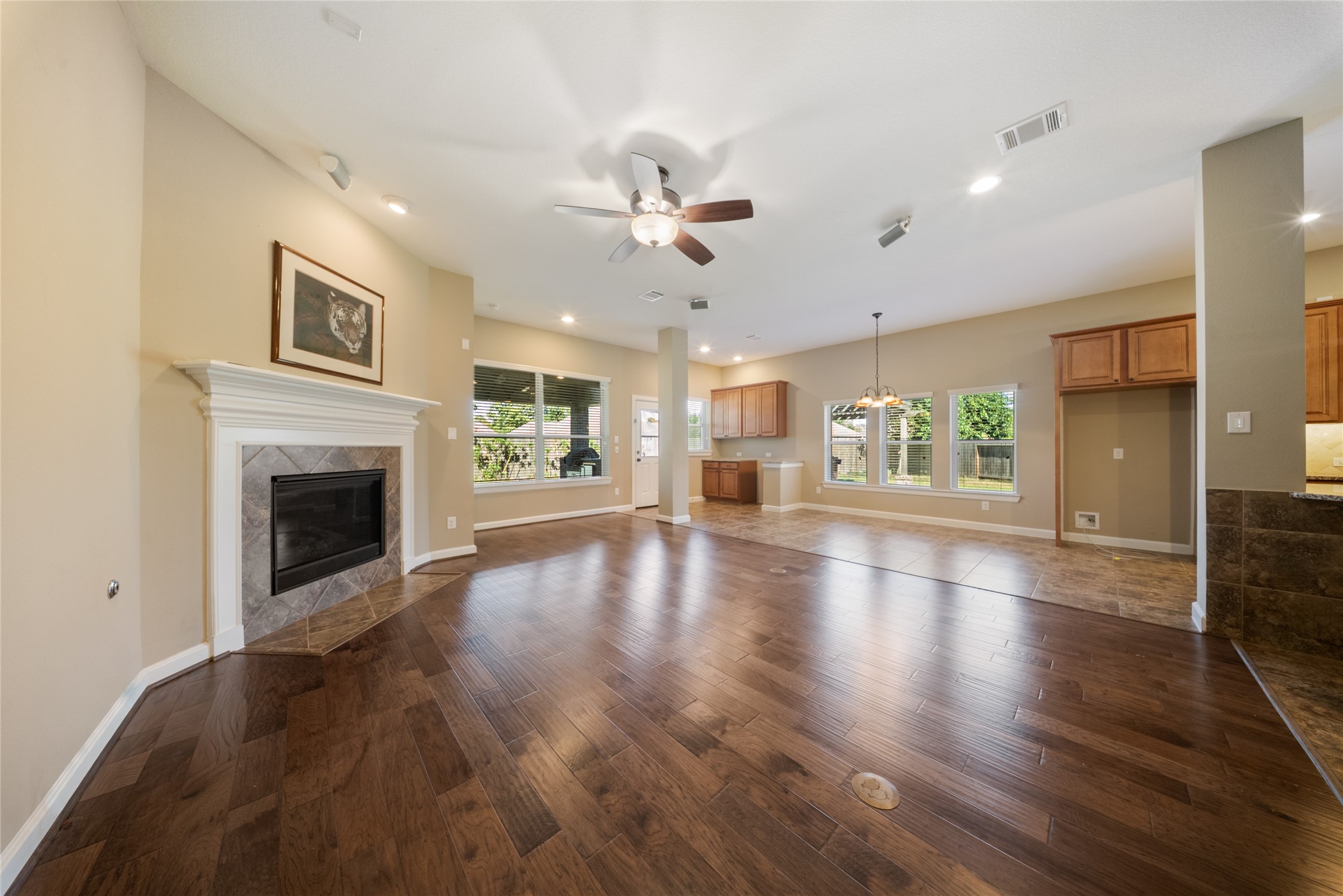 176 Castlegate Lane Houston, TX 77065 - Photo 5 of 33 a view of a livingroom with a fireplace a ceiling fan and windows