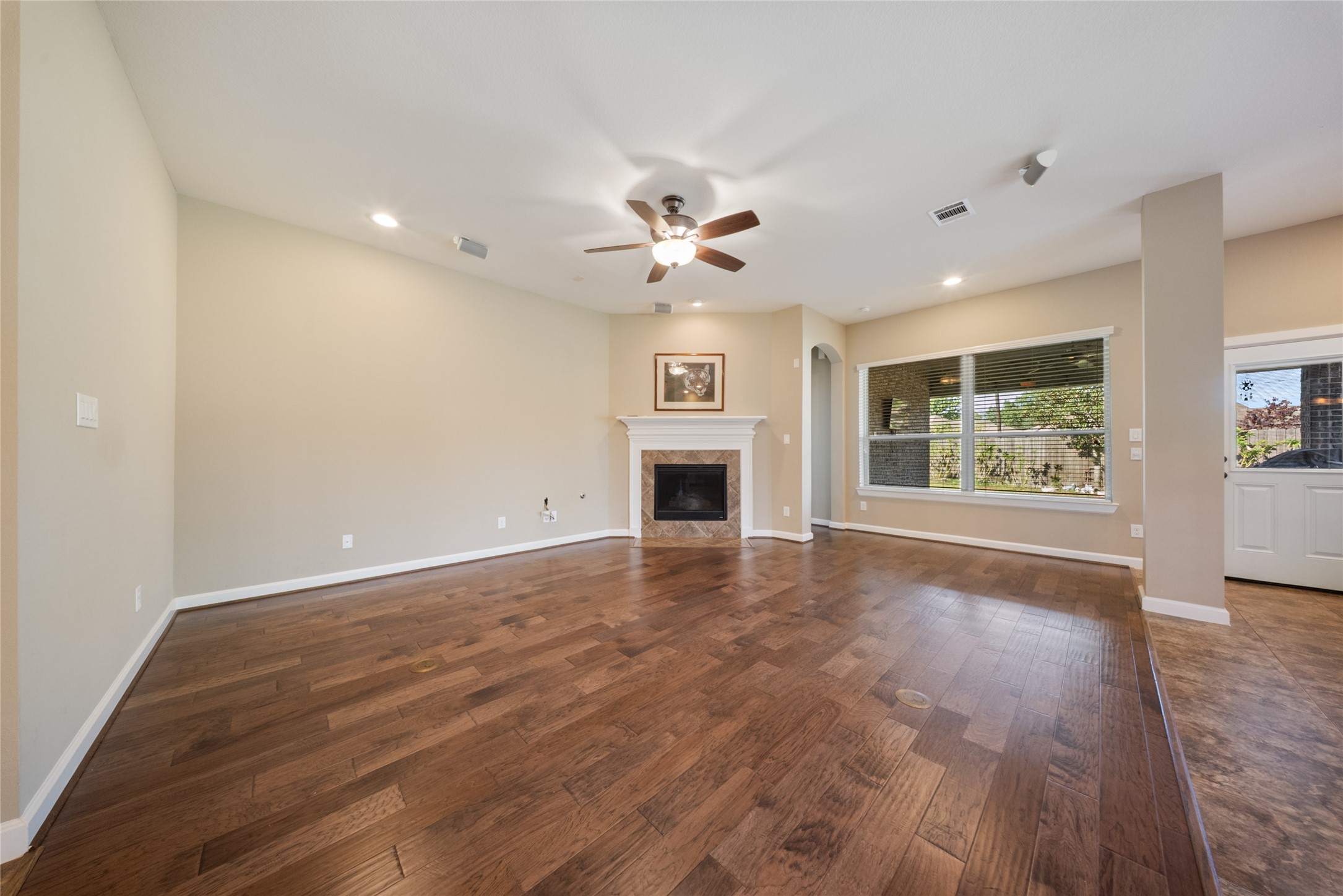 176 Castlegate Lane Houston, TX 77065 - Photo 7 of 33 a view of an empty room with a window and a kitchen
