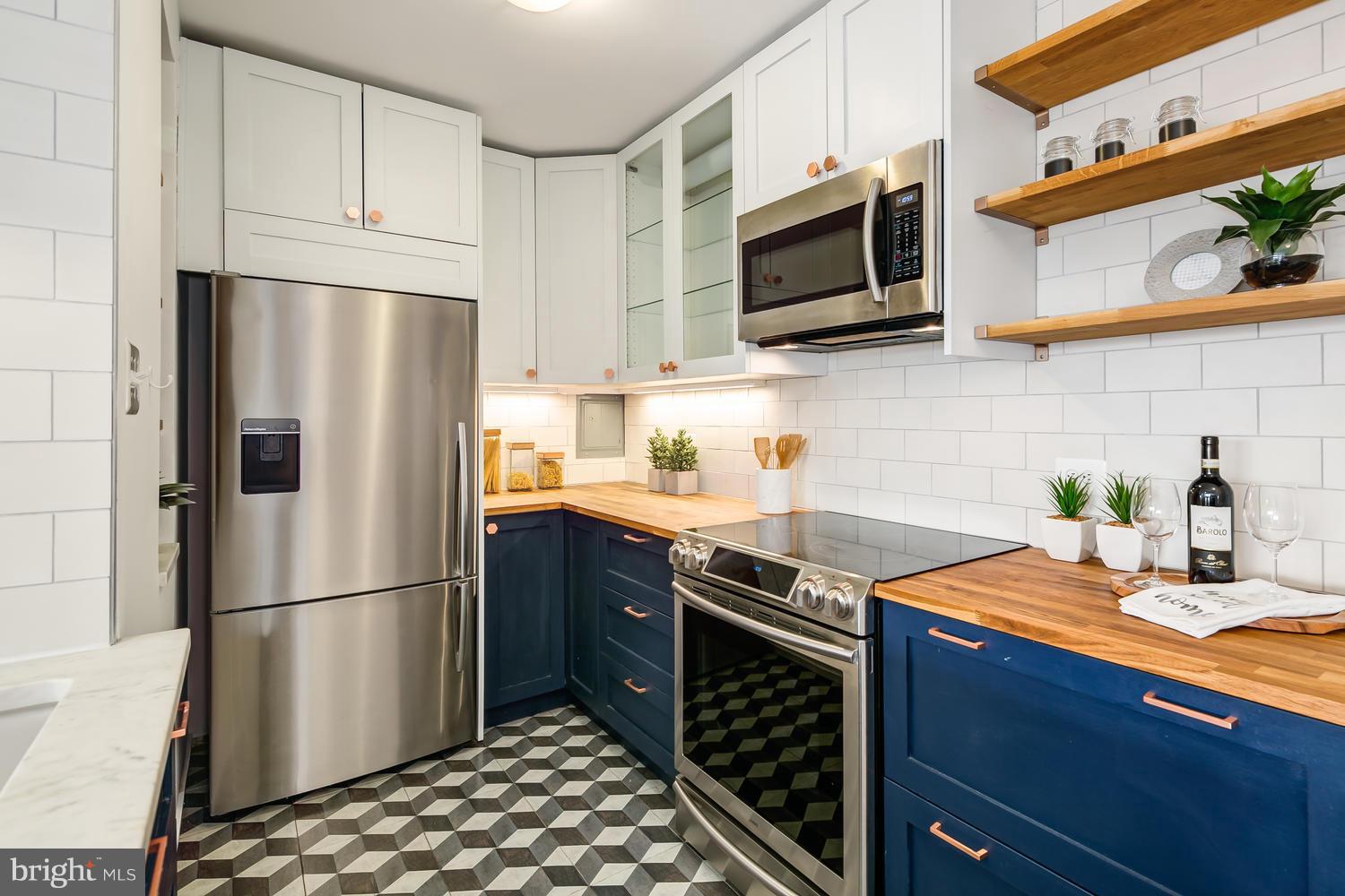 1301 Delaware Avenue Southwest, Unit N512 Washington, DC 20024 - Photo 2 of 28 a kitchen with stainless steel appliances a refrigerator microwave and sink