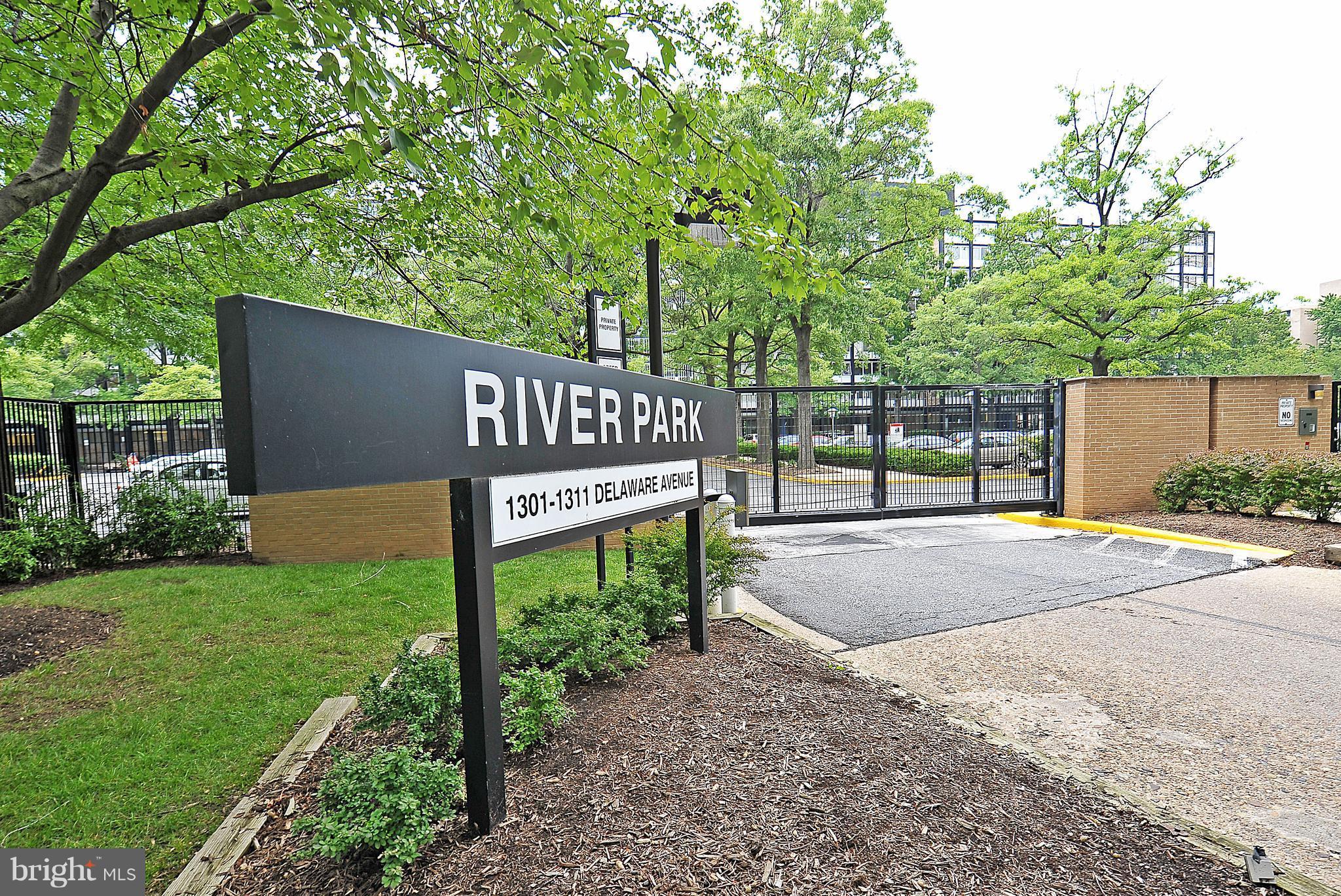 1301 Delaware Avenue Southwest, Unit N512 Washington, DC 20024 - Photo 19 of 28 a view of a street sign under a large tree