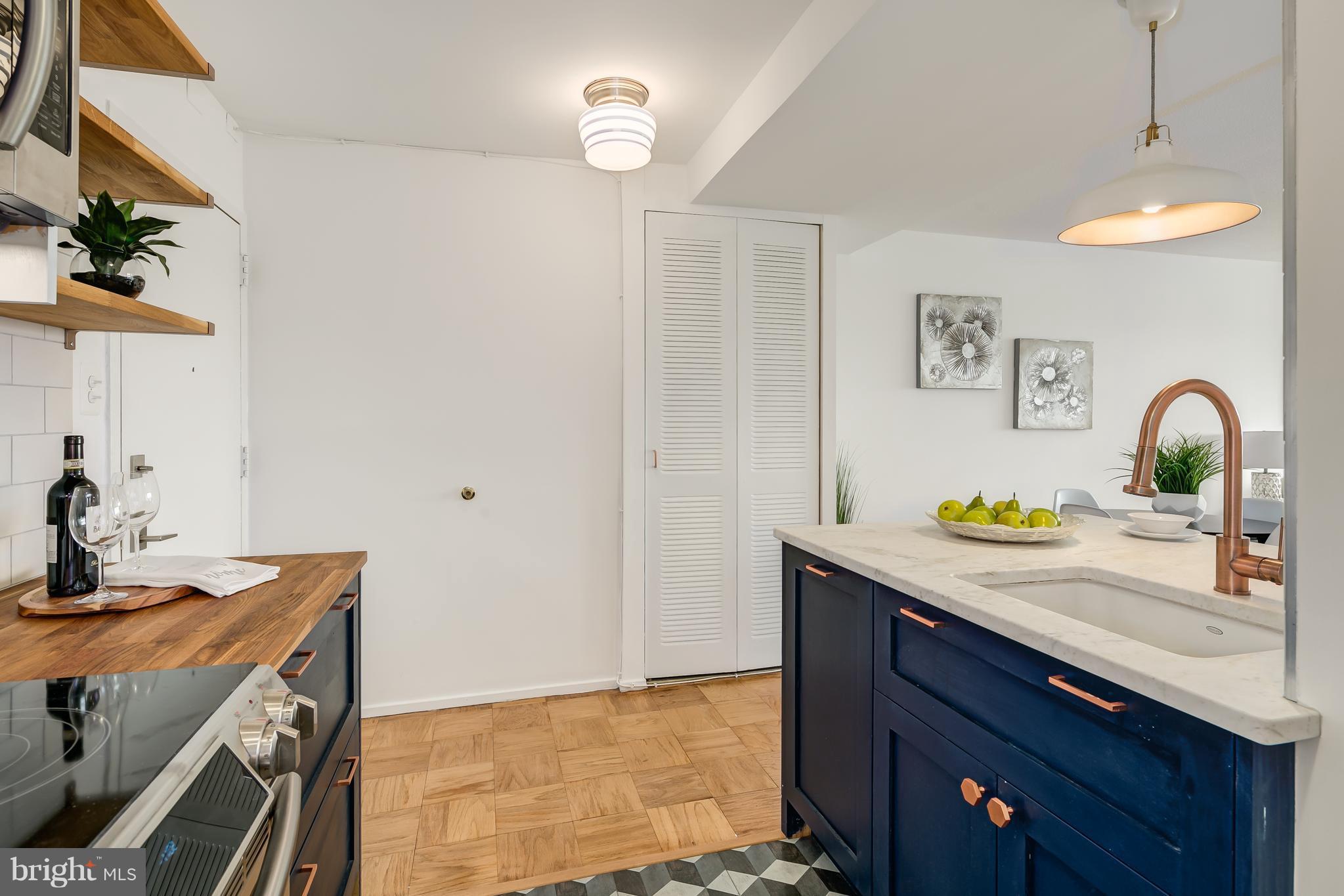 1301 Delaware Avenue Southwest, Unit N512 Washington, DC 20024 - Photo 3 of 28 a bathroom with a sink a light fixture and a mirror