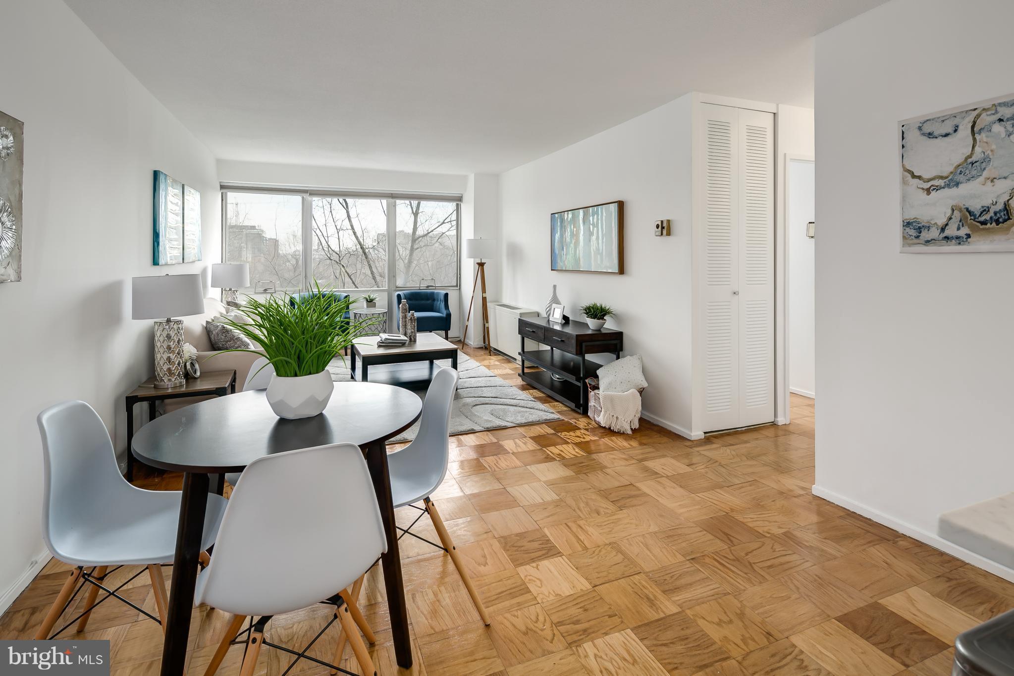 1301 Delaware Avenue Southwest, Unit N512 Washington, DC 20024 - Photo 5 of 28 a living room with furniture and a large window