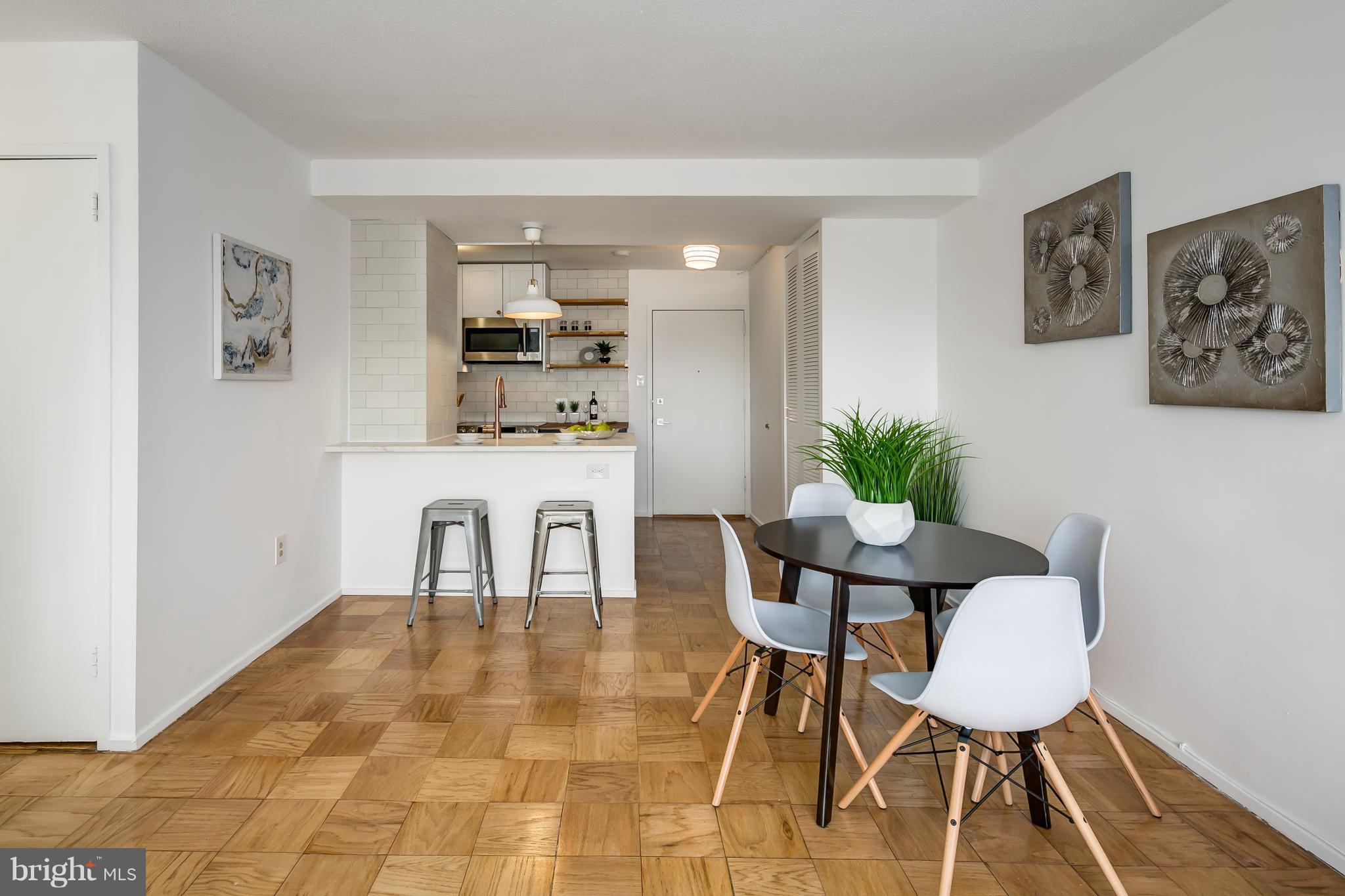 1301 Delaware Avenue Southwest, Unit N512 Washington, DC 20024 - Photo 7 of 28 a view of a dining room with furniture and wooden floor