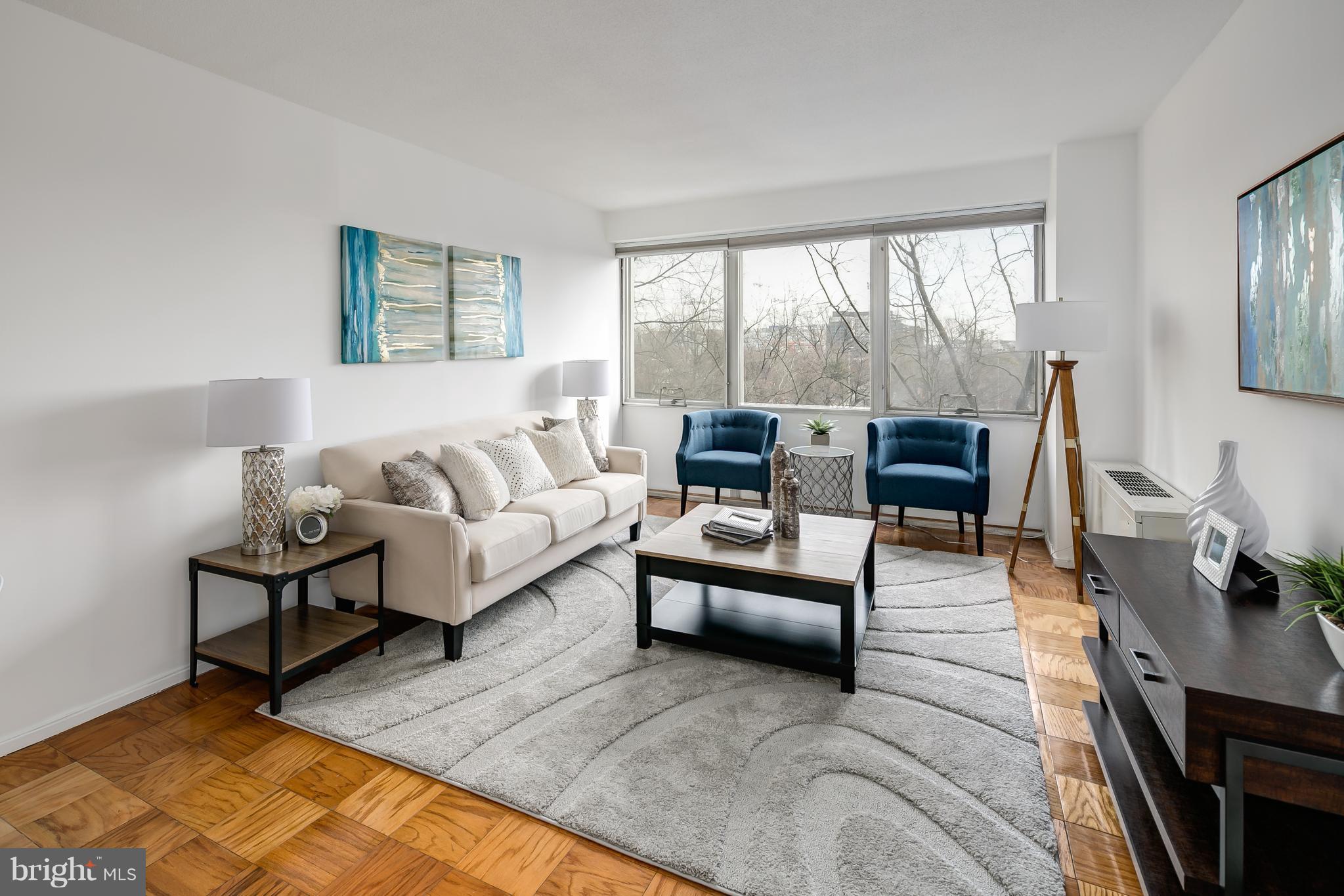 1301 Delaware Avenue Southwest, Unit N512 Washington, DC 20024 - Photo 8 of 28 a living room with furniture and a large window