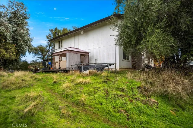 a backyard of a house with table and chairs