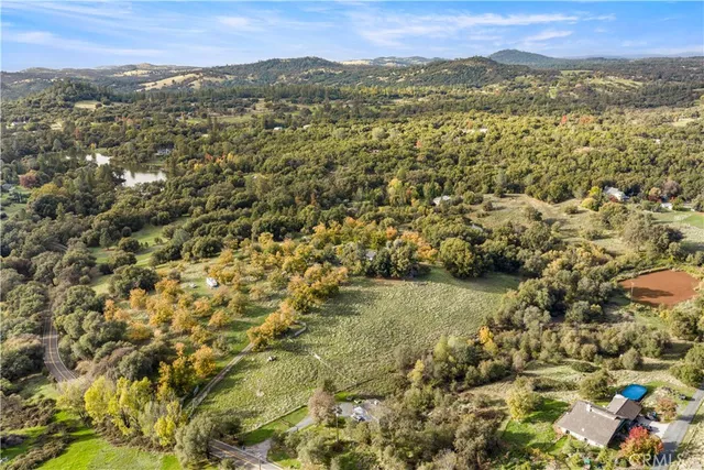 an aerial view of a house with a yard