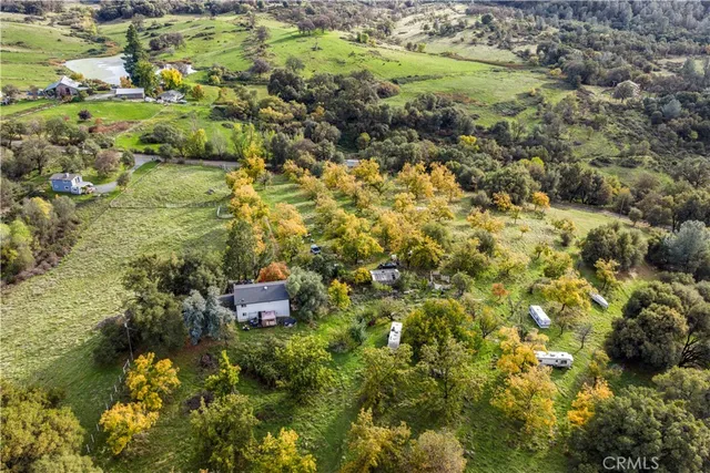 an aerial view of a house with a yard