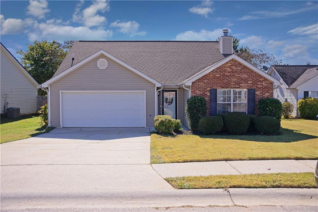 2313 Sugarlaef Trail Hampton, GA 30228 - Photo 1 of 1 front view of a house with a small yard