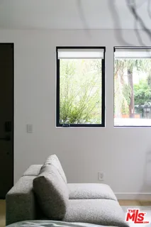 a living room with a couch and a large window