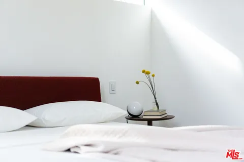 a bedroom with a bed and a table