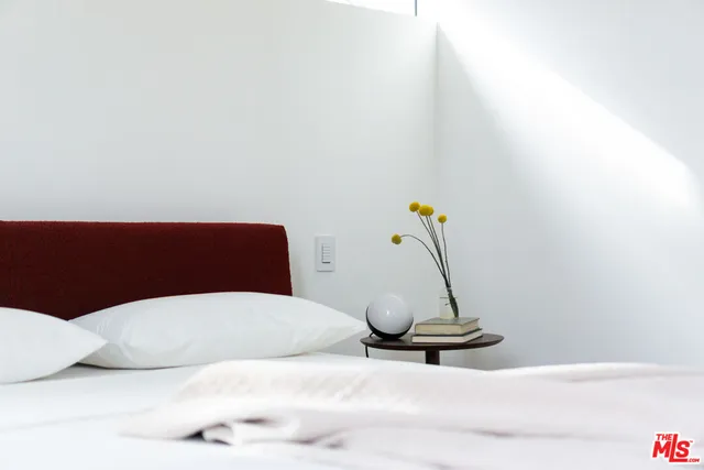 a bedroom with a bed and a table