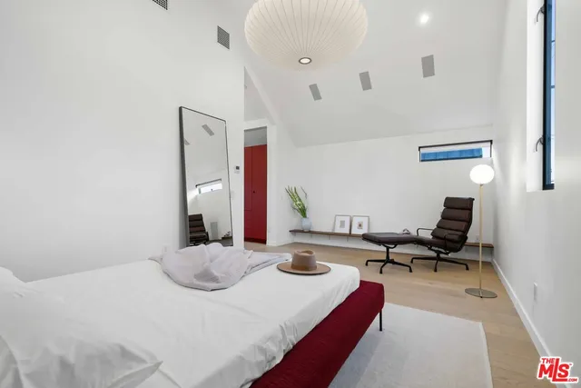 a bedroom with a bed and a couch