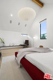 a bedroom with a bed and a desk