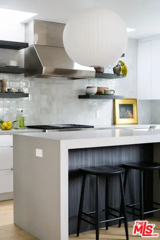a kitchen with a sink a stove and cabinets