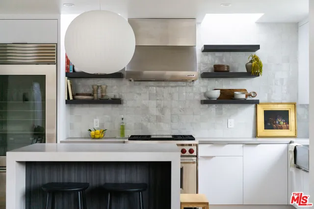 a kitchen with a sink a stove and cabinets