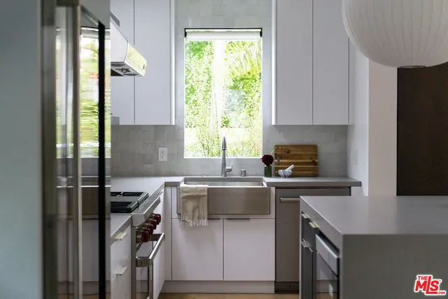 a kitchen with a sink a window and appliances