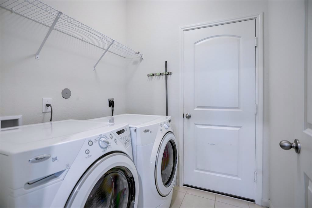1303 Emerald Stone Drive Rosharon, TX 77583 - Photo 10 of 25 Large utility room designed to handle busy household needs with ease and efficiency.