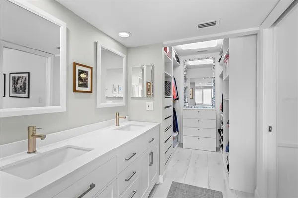 a spacious bathroom with a double vanity sink mirror and double