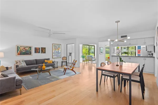 a dining room with furniture window and wooden floor