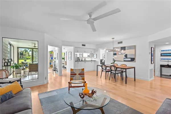 a living room with furniture and a wooden floor