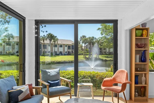 a outdoor living space with furniture and a floor to ceiling window