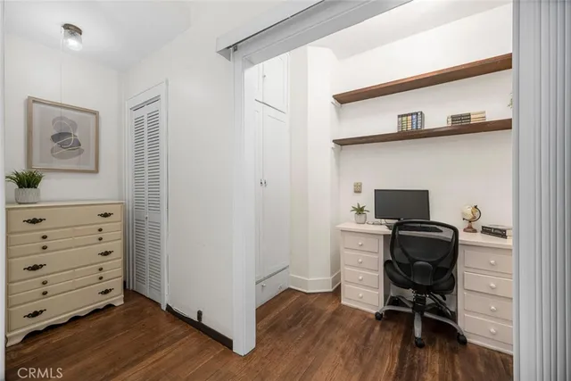 a view of a workspace with furniture and wooden floor