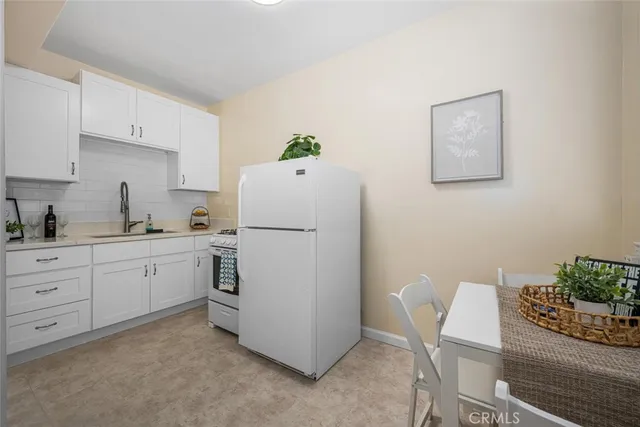 a utility room with cabinets washer and dryer