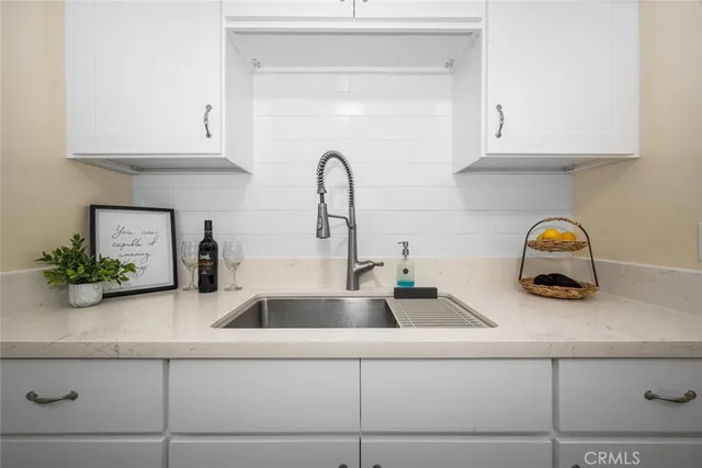 a kitchen with sink and cabinets