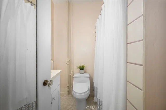 a white toilet sitting next to a shower